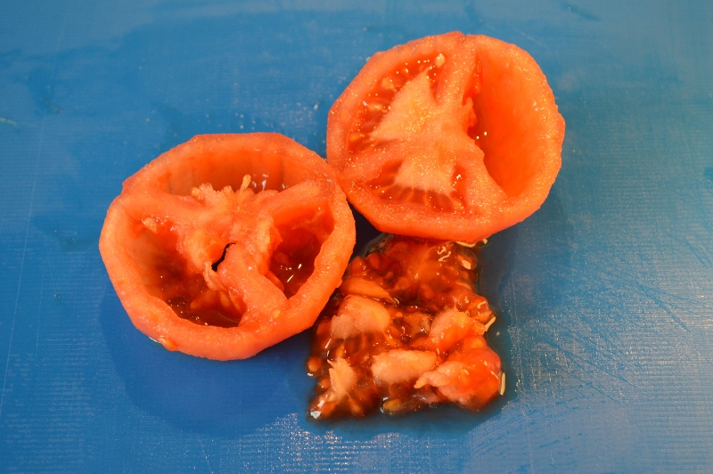 Partir el tomate por la mitad y retirar la pulpa